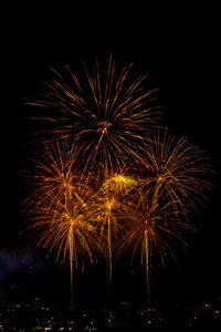 Low angle view of firework display at night