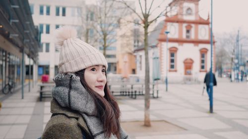 Woman wearing warm clothing in city