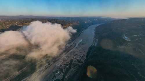 High angle view of land and sea against sky