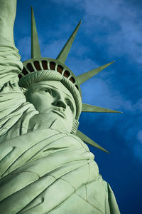 Low angle view of statue of liberty against sky