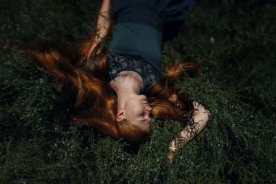 High angle view of woman lying on field