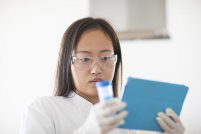 Scientist female with sample and tubes in a lab