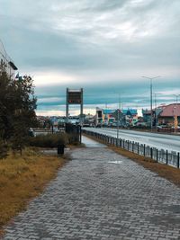 Bridge over river in city against sky