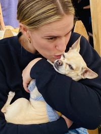 Close-up of woman kissing dog