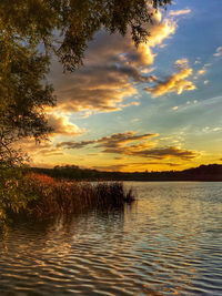 Scenic view of lake against sky at sunset