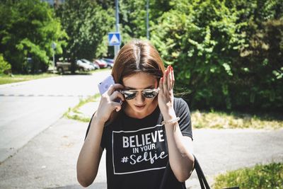 Portrait of young woman in sunglasses