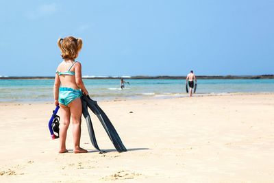 Rear view of girl on beach