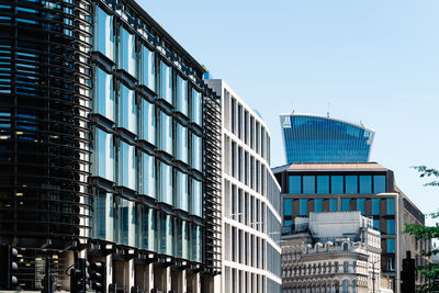 Cityscape of london with modern office buildings against blue sky