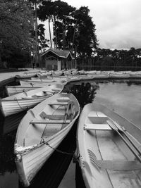 Boats moored in lake against sky