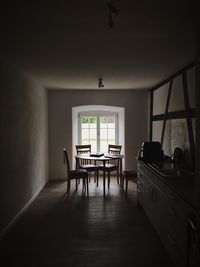 Empty chairs and table in building