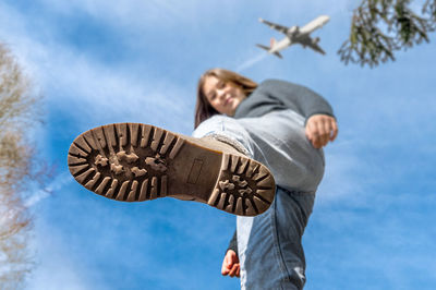Low angle view of man standing against sky