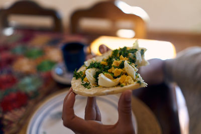 Close-up of person holding food in plate