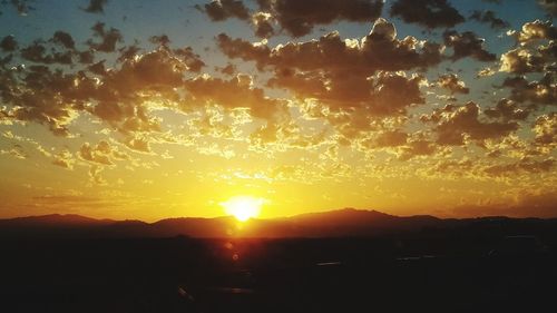 Silhouette landscape against sky during sunset