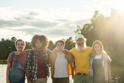 Friends standing against sky