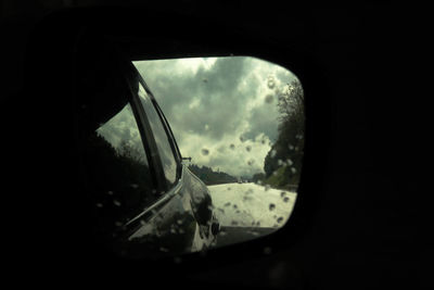 Reflection of sky on side-view mirror