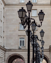 Low angle view of street light against building