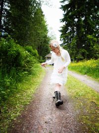 Rear view of girl walking on road