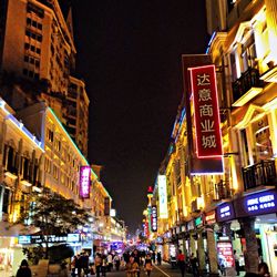 Illuminated city street at night