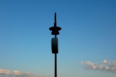 Low angle view of street light against blue sky