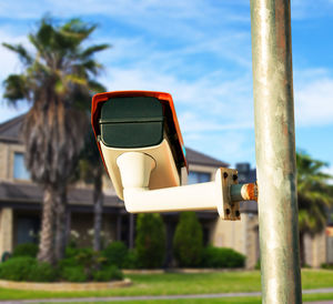 Close-up of sunglasses against sky on sunny day