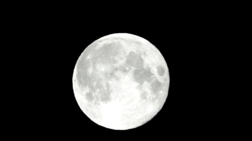 Low angle view of moon against sky at night