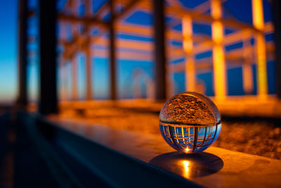 Close-up of illuminated light bulb on table