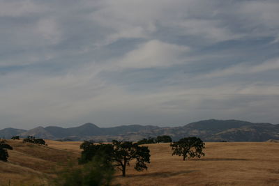 Scenic view of mountains against cloudy sky