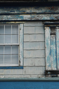 Close-up of window on blue door