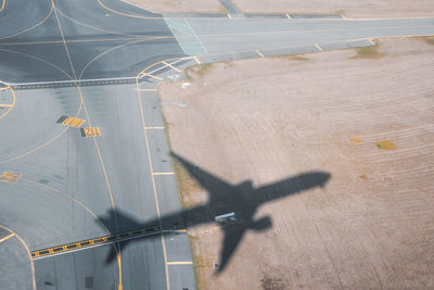 High angle view of airplane on airport runway