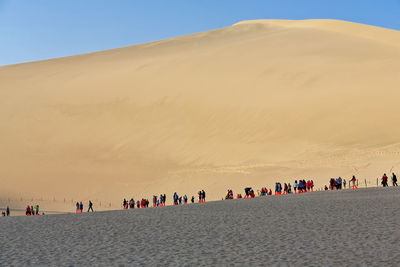 People on sand at desert