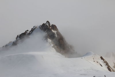 Scenic view of snow covered mountain against sky