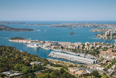 High angle view of town by sea against clear sky