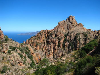 Scenic view of mountains against clear blue sky