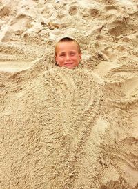 High angle portrait of boy in sand