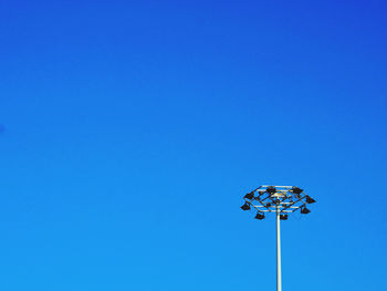 Low angle view of street light against clear blue sky