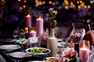 Luxury table settings for fine dining with and glassware, pouring wine to glass.