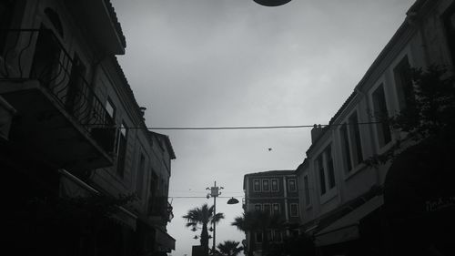 Low angle view of buildings in town against sky