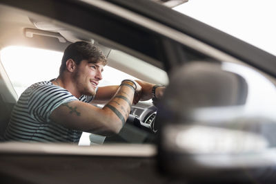 Portrait of young man in car