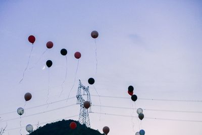Low angle view of balloons against sky