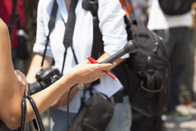 Cropped image of journalist holding microphone