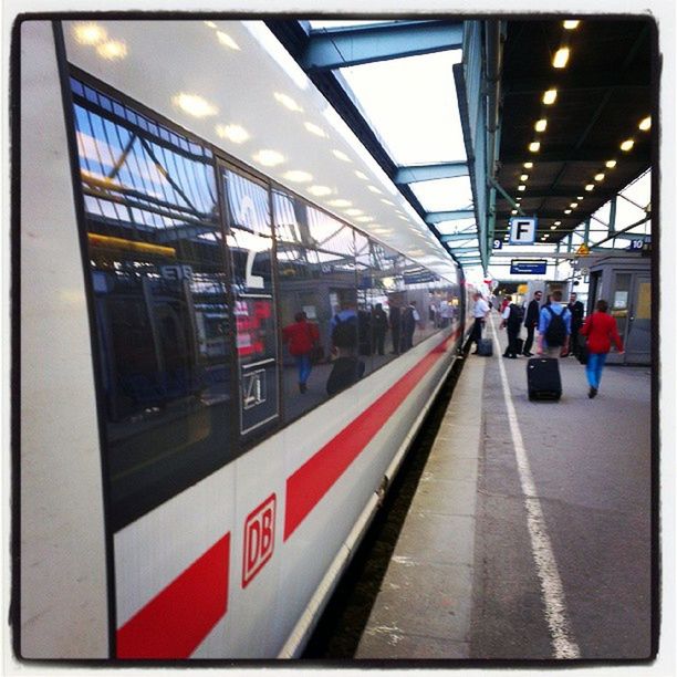 transportation, railroad station, railroad station platform, public transportation, rail transportation, railroad track, mode of transport, travel, train - vehicle, men, indoors, subway station, passenger train, passenger, architecture, city life, person, incidental people, built structure