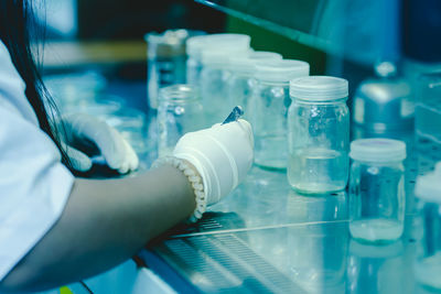 Cropped hand of scientist examining chemical in laboratory