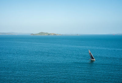 Scenic view of sailboat in sea against sky