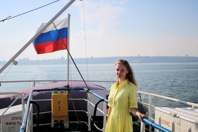 Portrait of woman standing on boat in sea