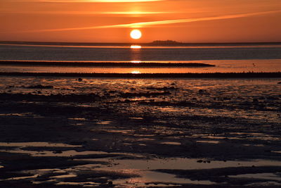 Scenic view of sea against romantic sky at sunset