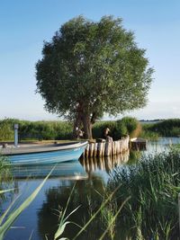 Swimming pool by lake against sky