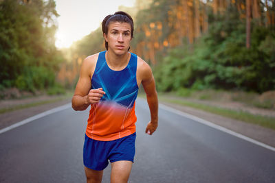 Young man running on road