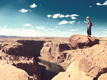 Low angle view of person standing on rock formation