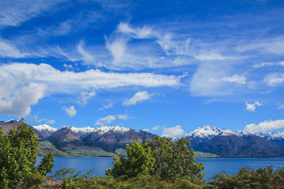 Scenic view of lake and mountains against sky