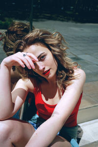 Portrait of young woman sitting outdoors